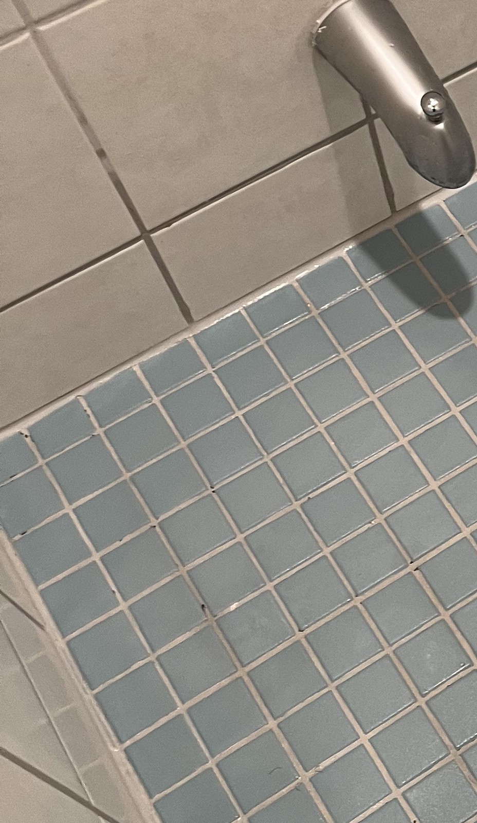 Clean bathroom floor tile and grout after bathroom detail cleaning.